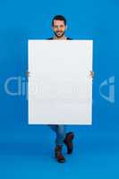 Handsome man holding a blank placard