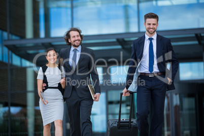 Businesswoman with colleagues walking