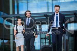 Businesswoman with colleagues walking