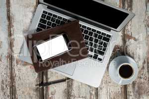 Laptop, smartphone, cup of coffee with diary and pen
