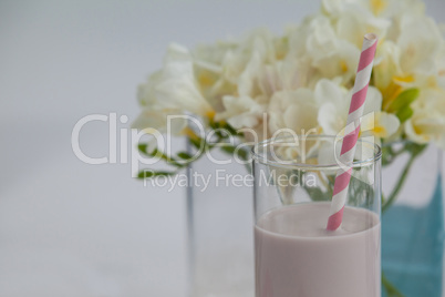 Milk shake in glass with a straw