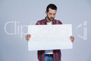 Man holding a blank placard