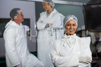 female butcher standing with arms crossed