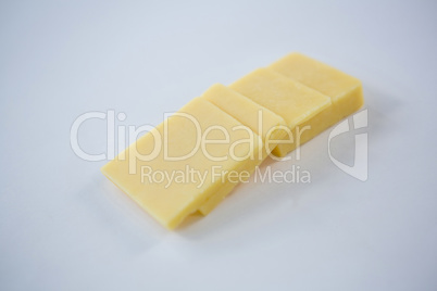 Slices of cheese on white background