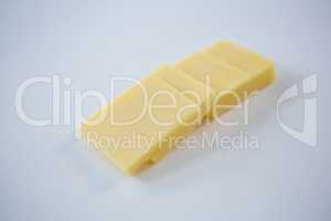 Slices of cheese on white background