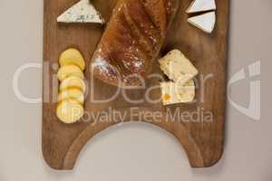 Variety of cheese with bread on chopping board