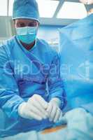 Male surgeon performing operation in operation theater