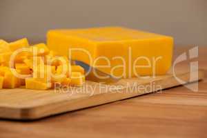 Cubes of cheese with knife