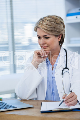 Female doctor working at her desk