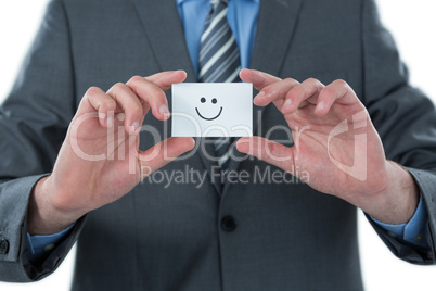 Businessman holding visitor card with smiley