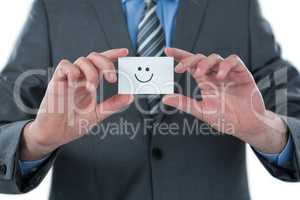 Businessman holding visitor card with smiley