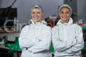 Female butchers standing with arms crossed