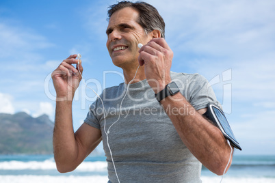 Smiling man listening to music on headphones