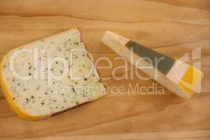 Slice of dutch gouda cheese on chopping board