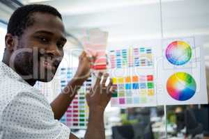 Graphic designer holding color swatch