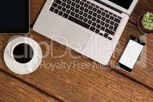 Digital tablet, laptop and smartphone with cup of coffee