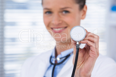 Smiling female doctor showing stethoscope