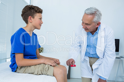 Doctor examining the knee of patient