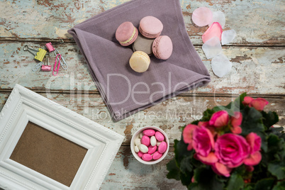 Flower vase, macaroons, candy and picture frame