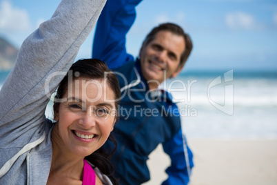 Couple performing stretching exercise