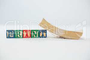 Print letter blocks with book on white background