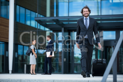 Businessman walking with his suitcase