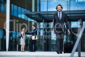 Businessman walking with his suitcase