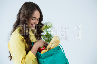 Beautiful woman carrying grocery bag