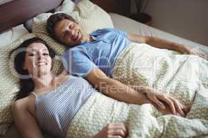 Romantic couple relaxing on bed