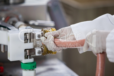 Butchers processing sausages