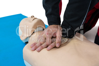 Paramedic practicing resuscitation on dummy