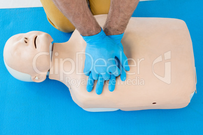 Paramedic practising cardiopulmonary resuscitation on dummy