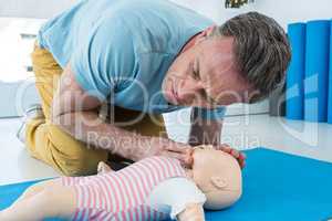 Paramedic practising resuscitation on dummy