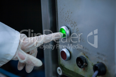 Butcher operating machine at meat factory