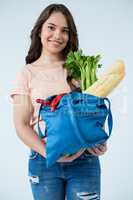 Beautiful woman carrying grocery bag