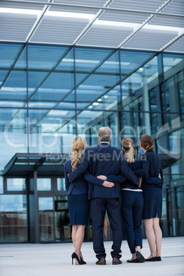 Businesspeople forming a huddle in office premises