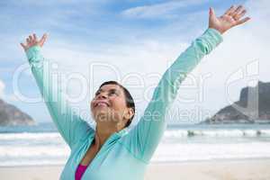 Happy woman standing with arms outstretched