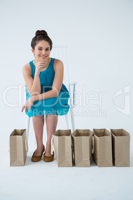 Woman sitting with shopping bags