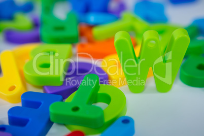 W alphabet standing between toy alphabet