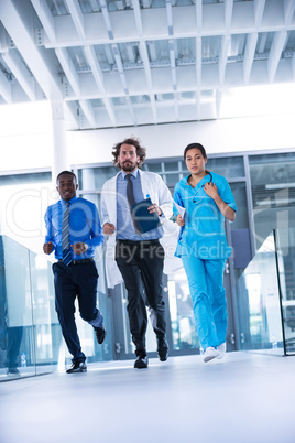 Businessman, doctor and nurse in hospital corridor