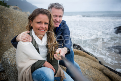 Happy couple taking a selfie at the beach