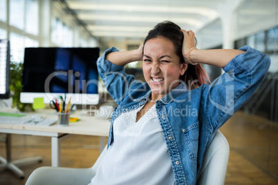 Frustrated female business executive at desk