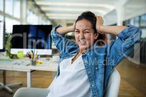 Frustrated female business executive at desk