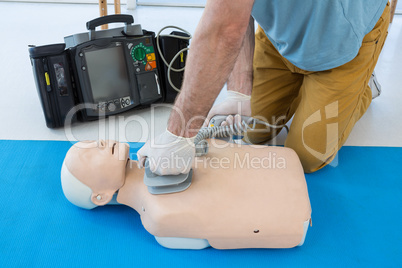 Paramedic practicing resuscitation on dummy