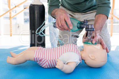 Paramedic practicing resuscitation on dummy