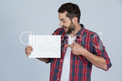 Happy man holding a blank placard