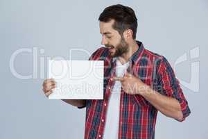 Happy man holding a blank placard