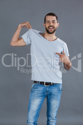 Cheerful man posing in grey t-shirt