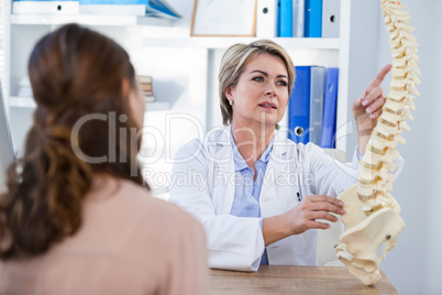 Doctor explaining anatomical spine to patient