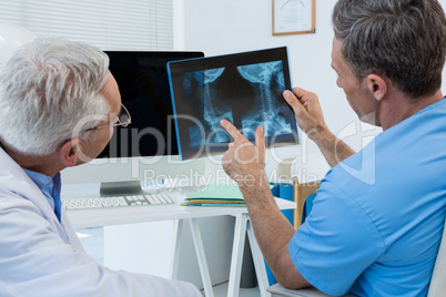 Surgeon and doctor discussing x-ray report